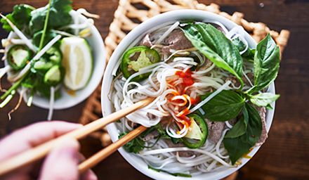 A dish of Asian cuisine enjoyed by someone using chopsticks