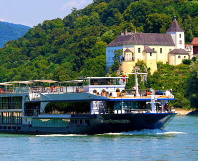 Avalon Waterways in the river with a yellow building in the background