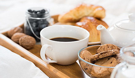 A tray of breakfast food items and coffee
