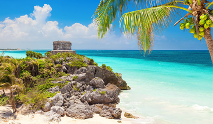 Old stone building overlooking beautiful blue water in Mexico