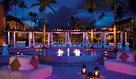 Pool area with cabanas at nights at a Secrets Resort in the Caribbean