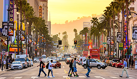 Busy street filled with cars, people, restaurants in California