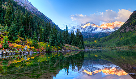 Snow covered mountains, water, lush landscaping in the Western U.S.